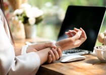 Woman holding wrist to ease pain